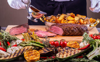 The berry sauce which is flowing down on a piece of fried meat