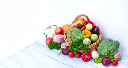 Farm products - basket of vegetables on blue wooden background.