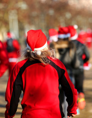 girl with blond hair running during the run of Santas