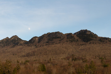 Moon rising over Grandfather Mountain and its suspension foot bridge in Linville, North Carolina near Boone.