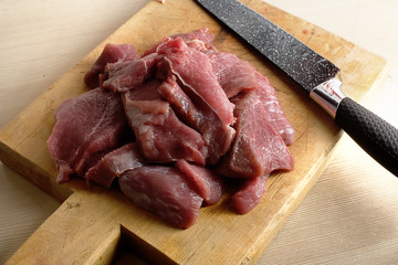 Pieces of fresh and juicy meat on the cutting Board