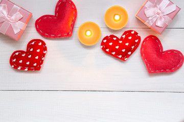 Red hearts and gift on white wooden background for Valentines day, copy space, top view.