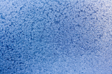Fototapeta na wymiar Winter blue background of snowflakes and frost