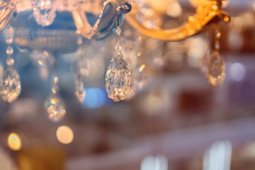 abstract image background of blur bokeh and crystal chandelier light equipment filter tone color...