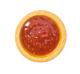 Sweet chili sauce in wooden bowl isolated on white background.Top view
