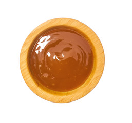 Orange sweet and sour sauce in wooden bowl isolated on white background.Top view