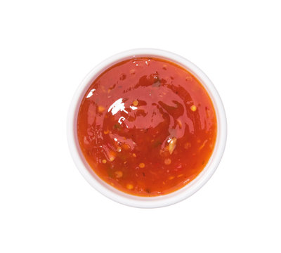 Red hot chilli pepper sauce in ceramic bowl isolated  on a white background.Top view