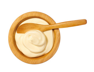 Mayonnaise sauce  in wooden bowl isolated on white background.Top view