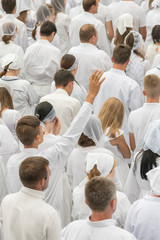 Many men and women pray to Jesus. vertical photo