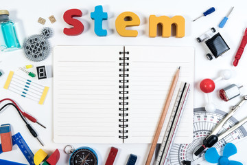STEM Education. Science Technology Engineering Mathematics. STEM word on book with education equipments for background.