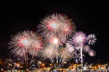 celebration colorful fireworks abstract background in the dark sky with copy space for festival holiday countdown to Happy New Year party in the park at night.