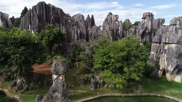 Flying over classic Chinese pavilion reveals beautiful Shilin Stone Forest in Yunnan province, China