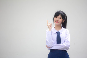 Portrait of thai high school student uniform beautiful girl pointing