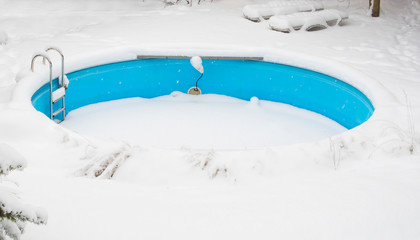 outdoor swimming pool in winter under the snow.