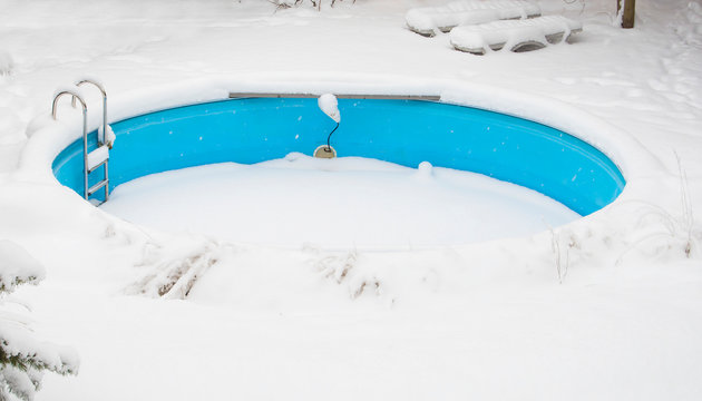 Outdoor Swimming Pool In Winter Under The Snow.