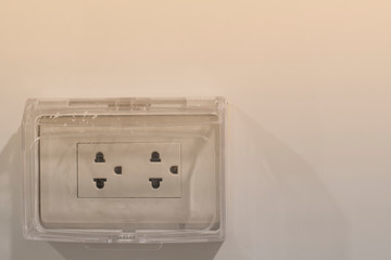 White plug on white wall.