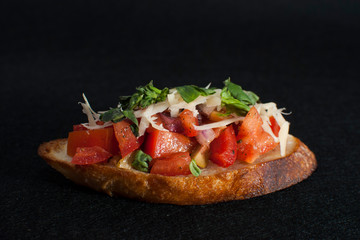 Bruschetta tomato sandwich on dark background