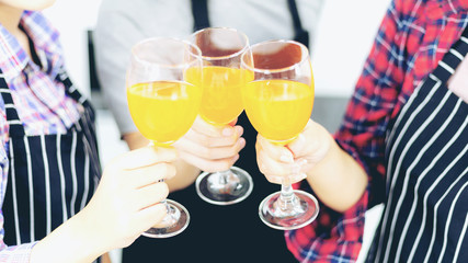 Three friends Enjoying Party glass , drinking orange juice cocktail together