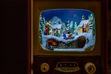 Christmas decoration. An entire village in a small antique TV, with the train and people on the...