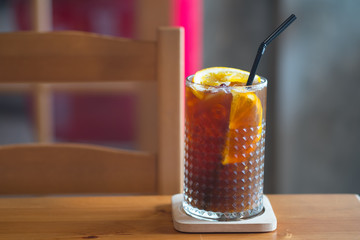 Cold coffee with ice and citrus in restaurant