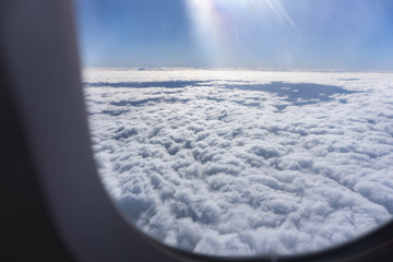 View of clouds and horizon from plane window