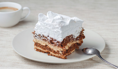Tiramisu cake with walnuts and coffee on a plate