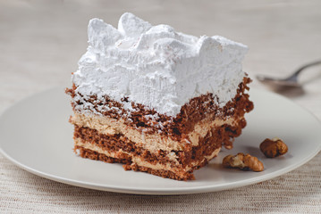 Tiramisu cake with walnuts on a plate
