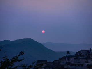 Red sun over temple