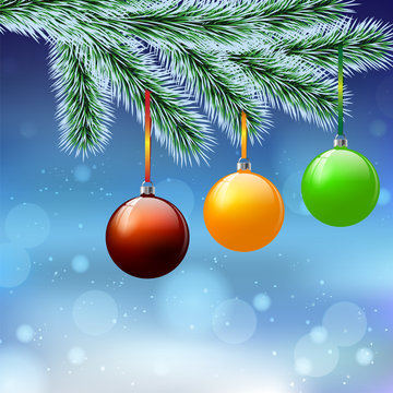 Christmas tree decorations on a frost-covered Christmas tree branch