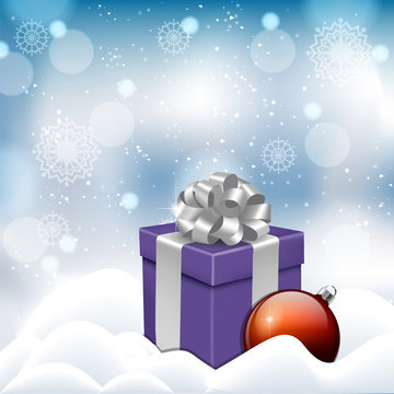 blue box with a Christmas tree toy in a snowdrift on a New Year's background