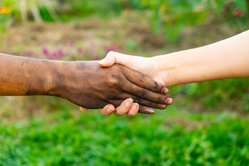 close up man and woman hands touching holding together on blurred background for love valentine day concept, shake hand with a dirty hand and a clean, Stained,