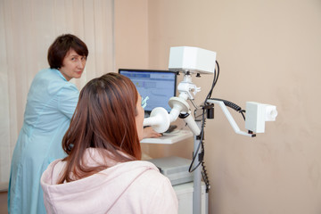 female doctor pulmonologist in a blue robe conducts research Impulse oscillometry girl. respiratory...