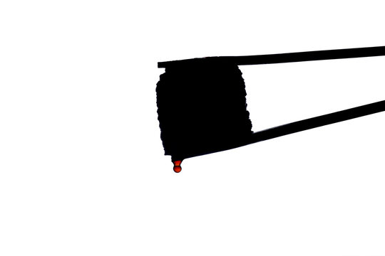 recommend clip art: sushi silhouette with drops of sauce flowing down on white isolated background, roll between chopsticks, food background, Japanese cuisine