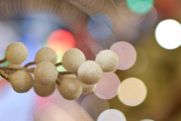 A bunch of terry white snow balls on the background of multi-colored bokeh. Christmas decorations