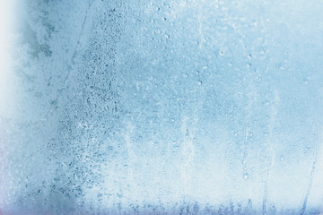 Frozen winter window pane coated shiny icy patterns. Frost background, closeup. Extreme north low temperature. Natural ice glass - obrazy, fototapety, plakaty