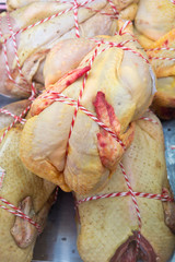 Whole raw chicken ready to sell at a French food market