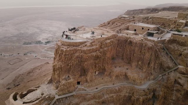 Masada fortress area Southern District of Israel Dead Sea area Southern District of Israel. Ancient Jewish fortress of Roman Empire on top of a rock in the Judean desert. front view from the air 4k