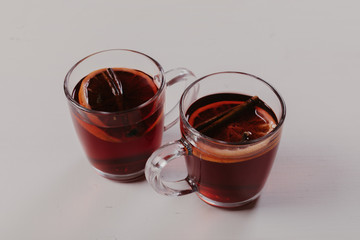 Mulled wine in mugs  on white wooden table.