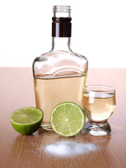 Glass cup with tequila on table