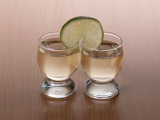 Glass cup with tequila on table