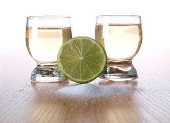 Glass cup with tequila on table