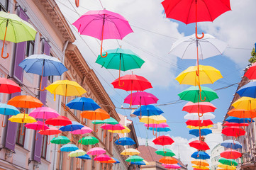 Fototapeta na wymiar Lots of umbrellas coloring the sky in the city