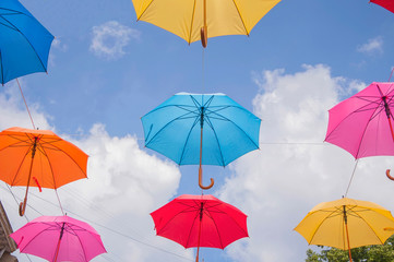 Colorful umbrellas against the sky in city settings