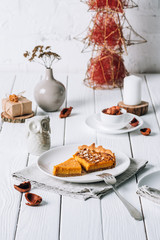 Pumpkin pie for Christmas. Place setting on white rustic table