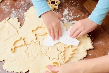 the child makes cookies from flour on the table