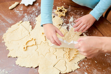 the child makes cookies from flour on the table