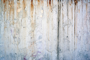 Old, rusty concrete wall with rust and cracks