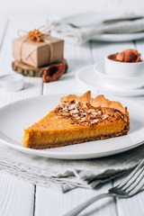 Pumpkin pie for Christmas. Place setting on white rustic table