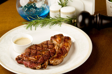 rib-eye steak with pepper sauce and rosemary