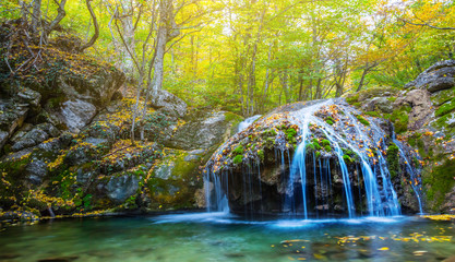 waterfall on a mountain river, autumn scene